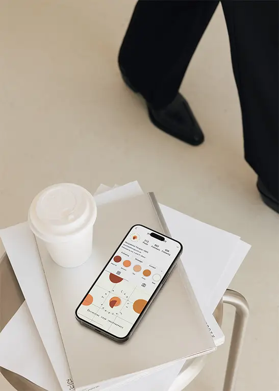 Coffee and phone with instagram open on top of books and magazines.