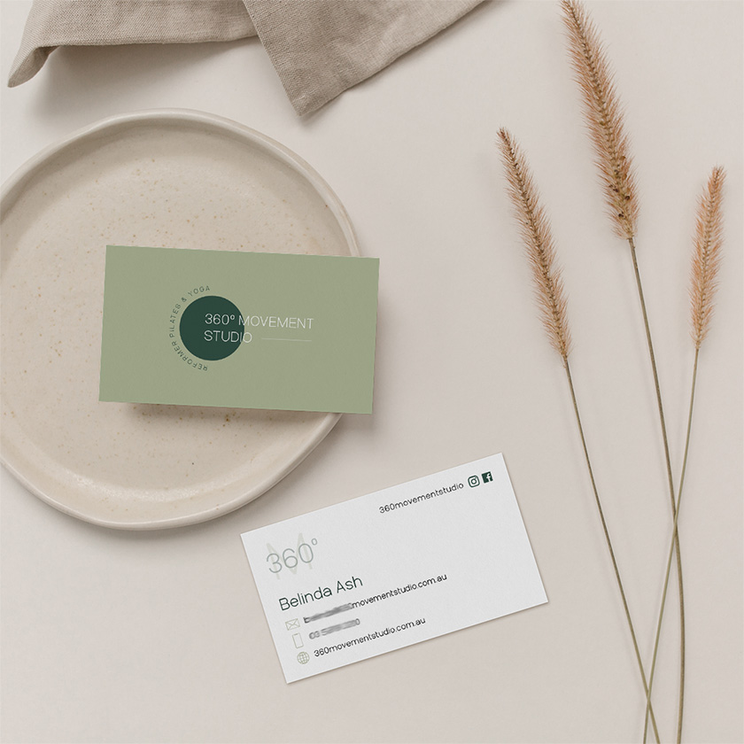 Earth-toned business cards for 360° Movement Studio styled with ceramic plate and dried grass