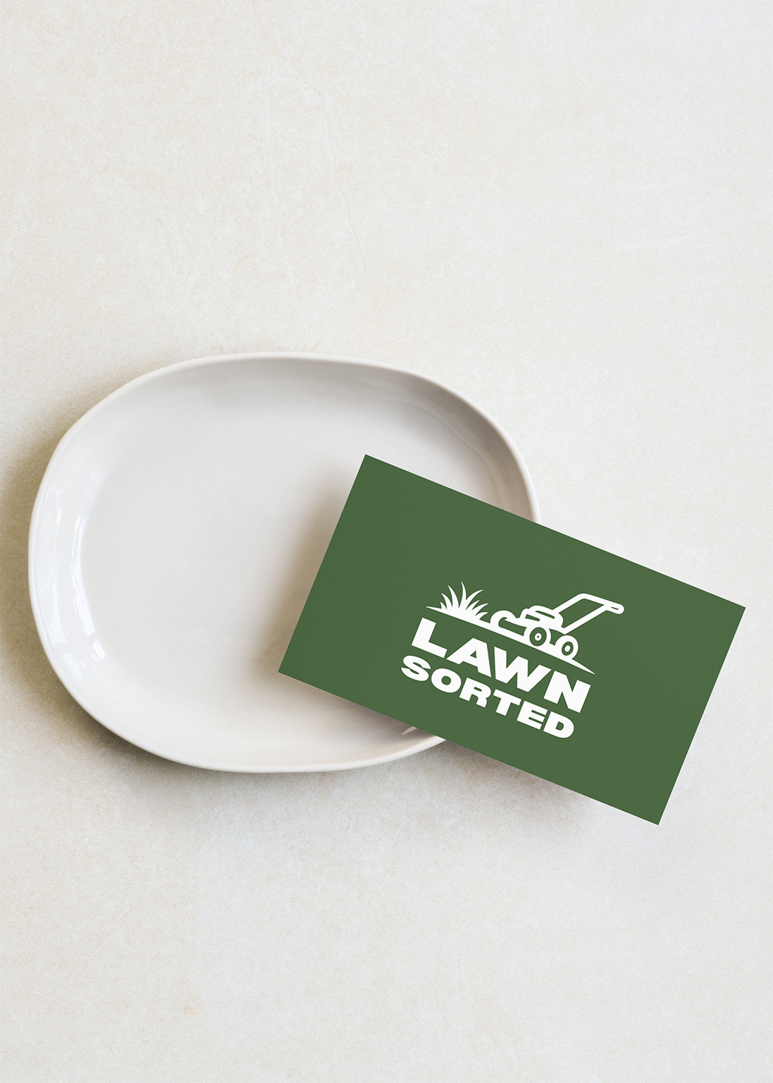 Lawn Sorted branded business card showing professional trade business identity with green color scheme and mower logo