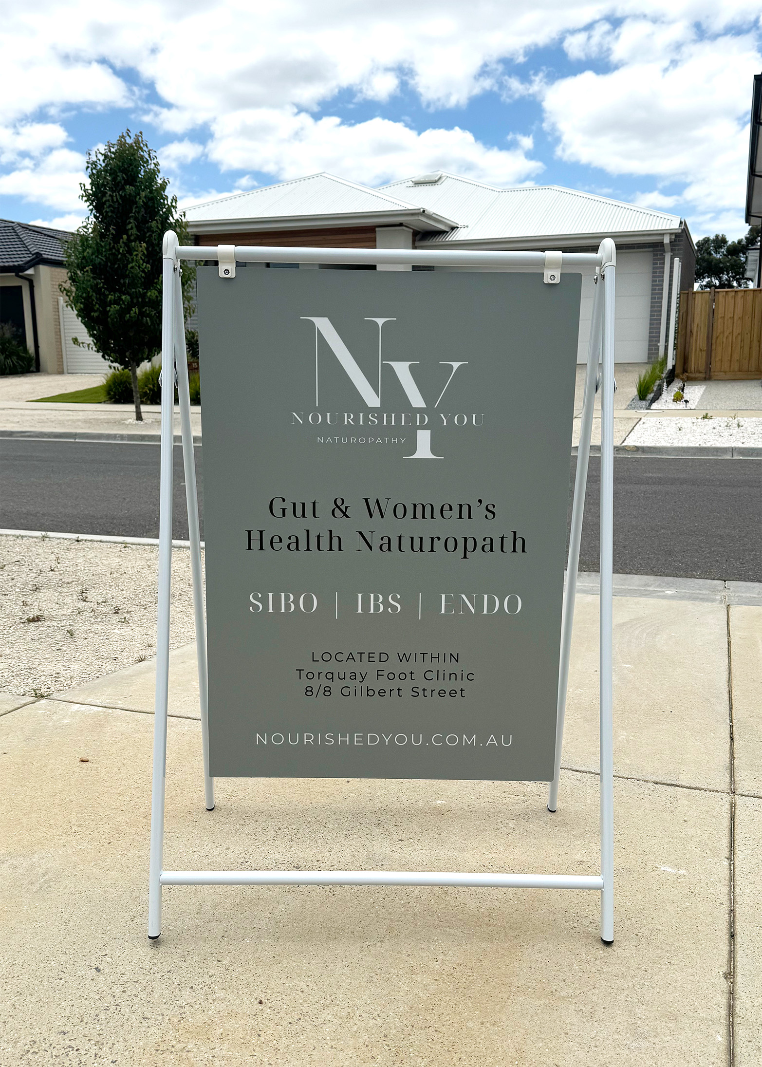 Nourished You naturopath A-frame signage displaying logo, specializations (SIBO, IBS, ENDO), and location in Geelong for women's health practitioners